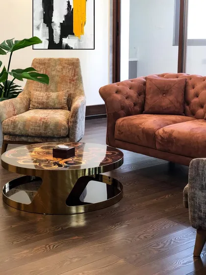 A close-up of the lounge area within the home gym. I chose rich textures and a unique brass coffee table to create a stylish and comfortable spot to unwind after a workout.