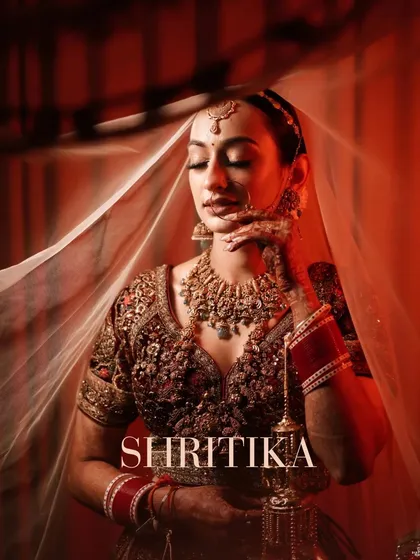 A bridal portrait is more than a photo; it's a piece of art. We use creative lighting and shadows, with the veil as a prop, to create this elegant and soulful portrait of the bride.