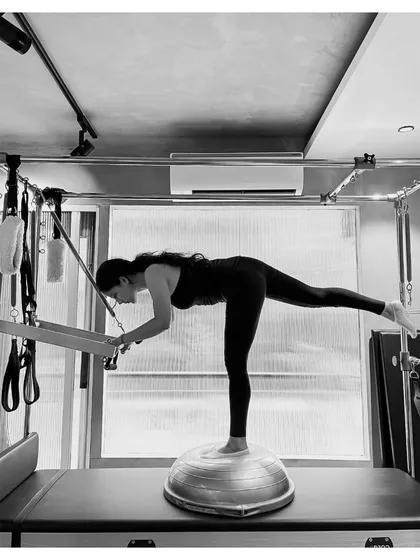 Pilates is the art of control. This exercise on the Reformer, using a BOSU ball, challenges stability and core strength, building the deep connection between mind and muscle.