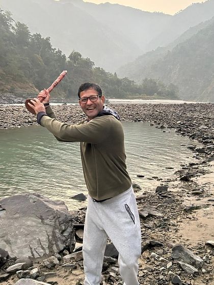 A participant playfully wielding a piece of driftwood by the river. Our nature excursions are not just about quiet reflection but also about finding moments of playfulness and joy.