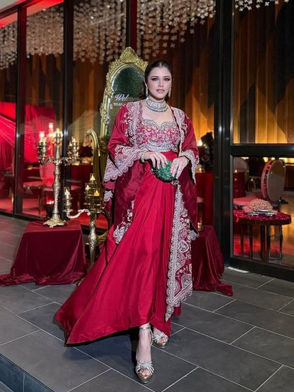 A full-length shot showing how the makeup complements the entire royal ensemble. The glam is designed to be impactful from a distance, ensuring the client looks stunning in every photograph.