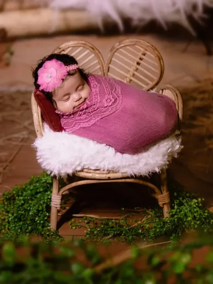 A peaceful newborn portrait. I use soft wraps and a tiny, cozy chair to create a safe and adorable setting for capturing your baby's first professional photos.