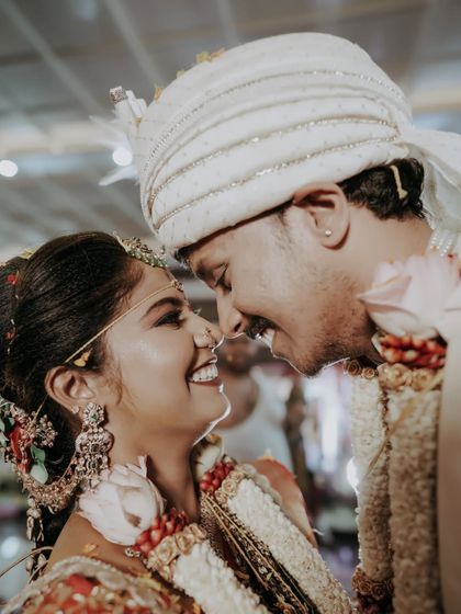 A close-up of the couple smiling at each other, capturing the pure happiness of their wedding moment.
