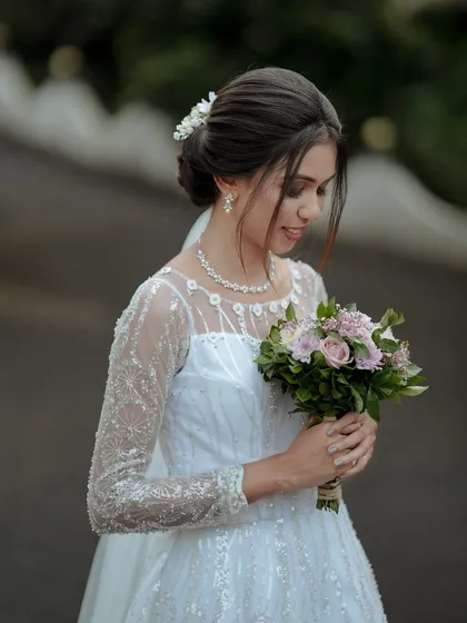 A serene portrait of a Christian bride, holding her bouquet just moments before the ceremony. This image reflects the quiet anticipation and elegance of a church wedding.