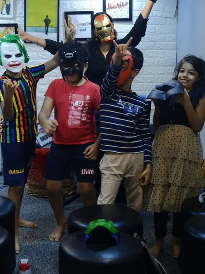 Learning music with us is about more than just lessons; it's about being part of a community. This fun photo from our Halloween celebration shows our students and teachers enjoying a spooky jam session together.