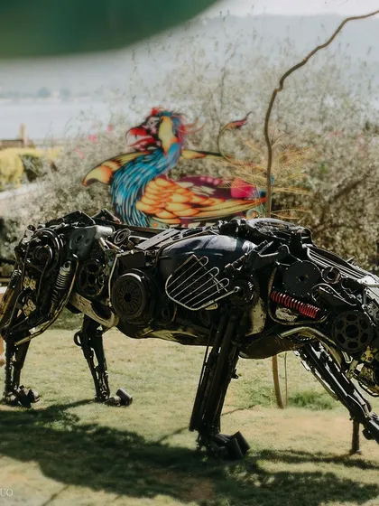 A scrap-metal panther prowls the lawns, with a colorful, mythical bird on its back. These art pieces were central to creating an immersive, avant-garde experience.