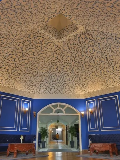 The reception ceiling at Hotel Tivoli Heritage Palace, covered in a custom wallpaper inspired by Mughal architectural patterns. The design adds a sense of grandeur and historical depth to the space.