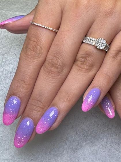 A closer look at the custom pink and purple glitter ombré on this dip powder manicure. The fine glitter is blended seamlessly for a sparkling, magical effect.