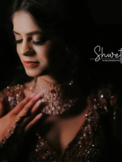 A classic, elegant portrait of the bride on her engagement day. The soft lighting and her gentle pose highlight the intricate details of her gown and her serene expression.