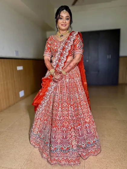 A full-length shot of the client in her gorgeous orange lehenga. She looks like royalty, ready to celebrate her child's special milestone.