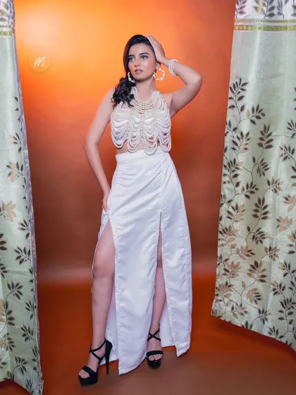 The model posing confidently, showcasing the unique outfit and makeup.