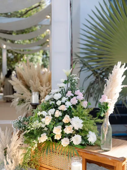 A bohemian Roka ceremony with pampas grass, soft florals, and rattan furniture. The aesthetic is light, airy, and effortlessly chic.