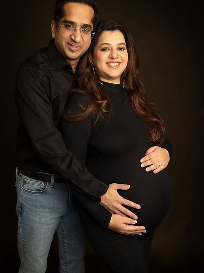 A classic couple's portrait, with a protective hand on the baby bump. A simple and elegant way to capture your journey together.