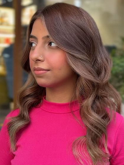 A three-quarter view of the classic transformation, showing how the blonde highlights are blended through the mid-lengths and ends for a natural yet impactful result.