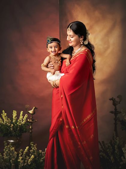 A stunning portrait of a mother and her little Krishna. The rich colors and her loving gaze make this a powerful image.