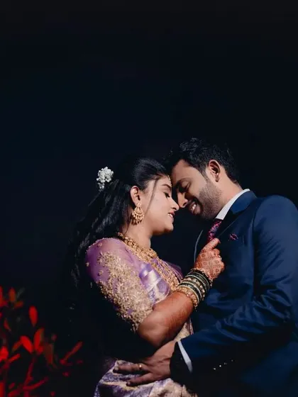 A romantic nighttime portrait of a couple. The intimate pose and dark background create a moody and cinematic feel, perfect for a reception shoot.