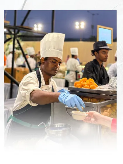 A chef at our live chaat counter, ready to serve. Our team's professionalism and passion are evident in every interaction with our guests.