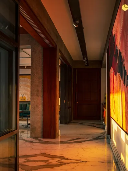 The completed corridor at 'The Canvas,' now a gallery-like space with dramatic lighting highlighting a large piece of art. This shows the transformation from a simple passage to an experiential journey.