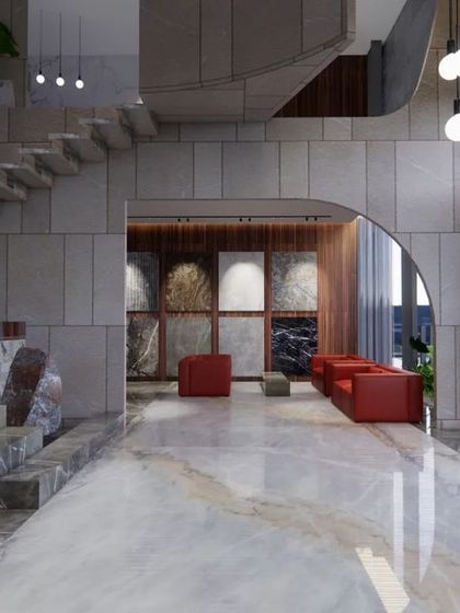 The main display area within the Vogue Marmi showroom. A cantilevered marble staircase and an arched entryway frame the stone slab displays, turning the product into a central feature of the architectural experience.