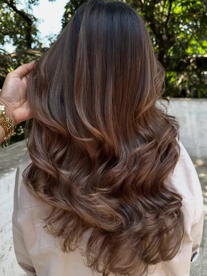 Another beautiful holiday hair transformation. We refreshed her color with a mix of beige and ash tones for a cool, sophisticated brunette look.