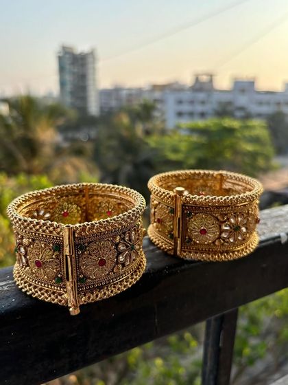 Our premium bridal kadas placed on a ledge, showing their sturdy build and intricate design from the side.