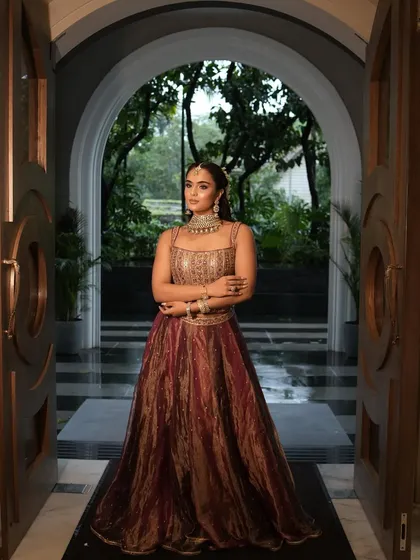 A complete look at this stunning bridal Mehendi style. The rich, multi-toned lehenga was paired with a glamorous makeup look featuring a shimmery eye, glowing skin, and a beautiful long ponytail adorned with mogra flowers.