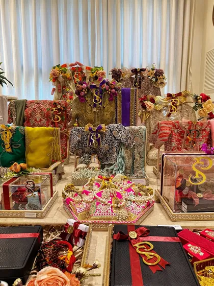 A breathtaking display of a complete bridal trousseau. Each tray tells a part of the bride's story, from her designer ensembles to her precious jewelry and accessories.