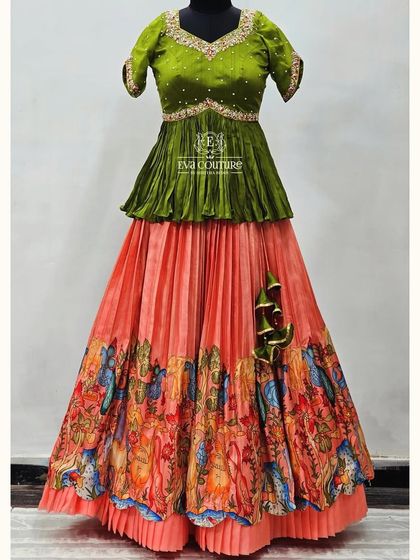 A beautiful layered gown with a peach-colored Kalamkari print skirt, paired with an olive green peplum blouse.