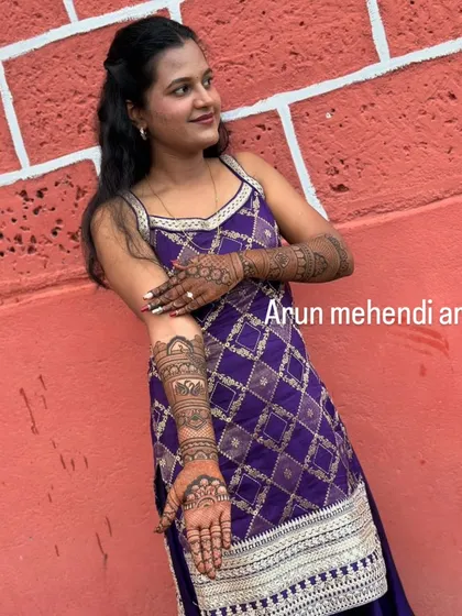 This client chose a stylish design that extends up one arm. The geometric diamond pattern on her dress is reflected in the henna art.