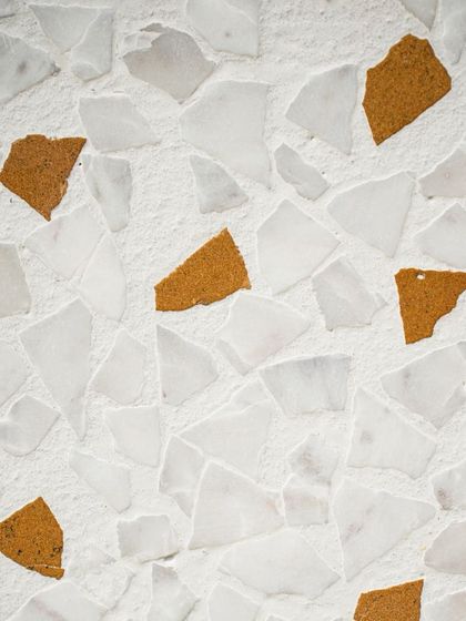 An extreme close-up of the leather-finish surface, showing the texture of the unpolished stone and concrete.