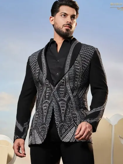 This tuxedo jacket features a unique geometric pattern in silver and black beadwork, covering the lapels and front panels for a mesmerizing effect.