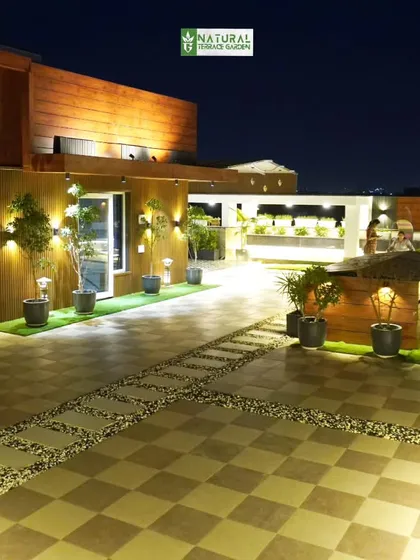 The Palam Vihar project at night, showing the full extent of the lighting design across the expansive checkered patio and garden areas.