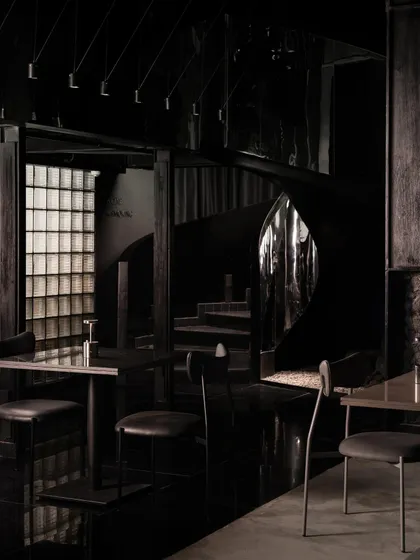 A glimpse of the staircase through a narrow opening, reinforcing the theme of concealment and discovery.