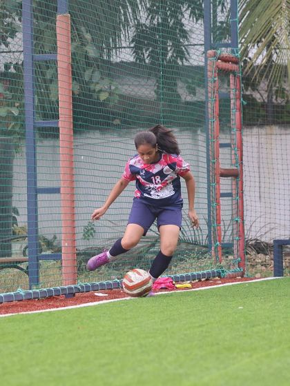 A player from our girls' team executing a powerful kick during a league match. This demonstrates the technical skill honed during our training sessions.