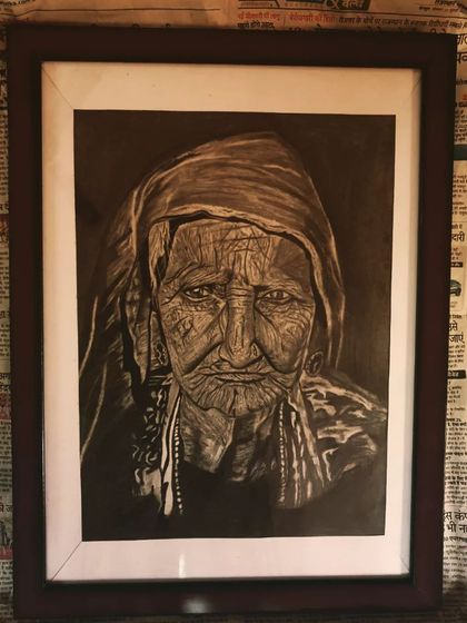 A powerful and detailed charcoal portrait of an elderly woman, focusing on the expressive lines of her face. This is a framed A3 artwork.
