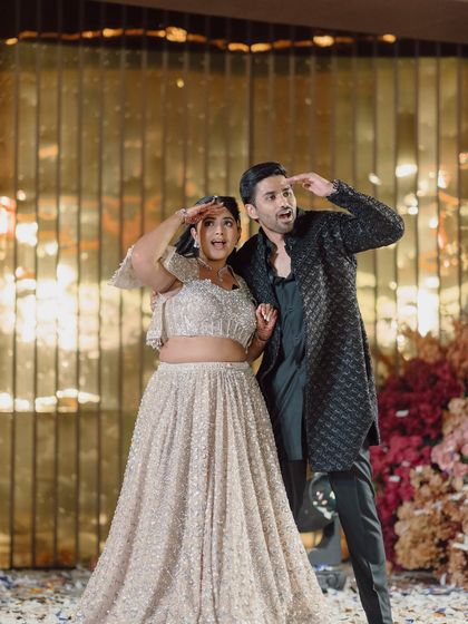 A fun, candid moment of the couple on stage, showing their playful side during the Sangeet night.