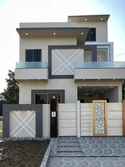 We create modern home designs that are stylish and fit within a practical budget. This exterior features a simple yet elegant composition of geometric patterns, a glass balcony railing, and a patterned driveway, delivering a high-end look efficiently.