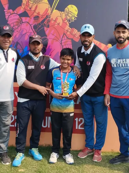 A group of coaches congratulating Saujas Jaiswal for his match-winning performance.