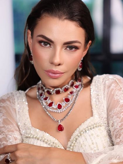 A close-up on the magnificent ruby and diamond necklace, the centerpiece of this modern bridal look.