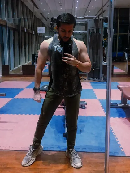 A mirror selfie showing arm and shoulder definition. My online coaching provides you with the tools to achieve this kind of lean, muscular physique.