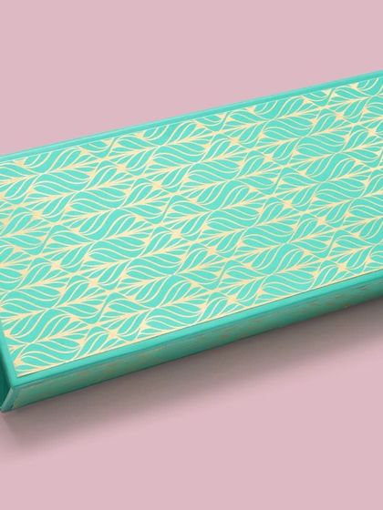 A simple yet elegant turquoise gift box with a leaf pattern. The clean background ensures the focus remains entirely on the product.