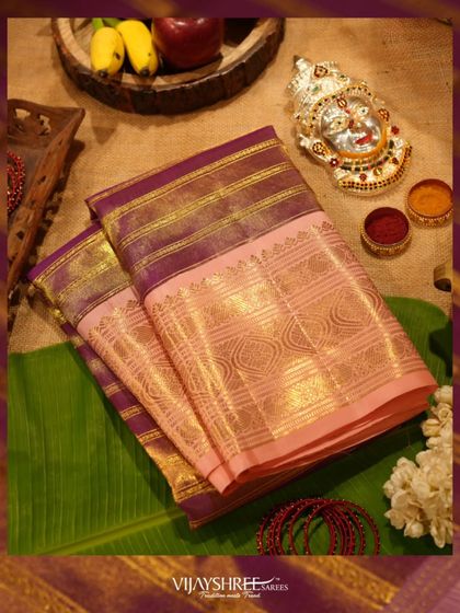 A vintage Kanjivaram tissue saree in pink and maroon, with intricate gold zari, perfect for Varamahalakshmi.
