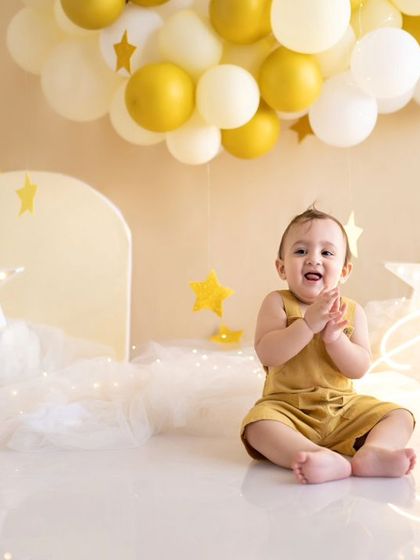 A magical, starry night theme for this little one's first birthday. The golden balloons and twinkling lights create a dreamy atmosphere.