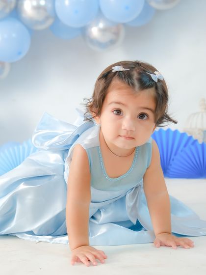 The birthday girl on the move. I make sure to capture a variety of poses, including crawling and exploring, to show off their new skills.