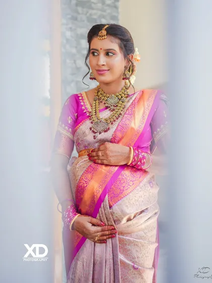 A candid portrait of the mother-to-be, her hand gently resting on her baby bump, capturing the serene joy of the celebration.