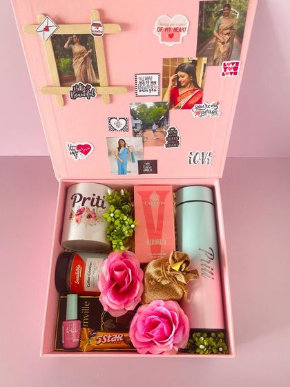 Inside the Valentine's box, a fully customized gift with a personalized mug and flask, perfume, chocolates, and a photo collage on the lid.