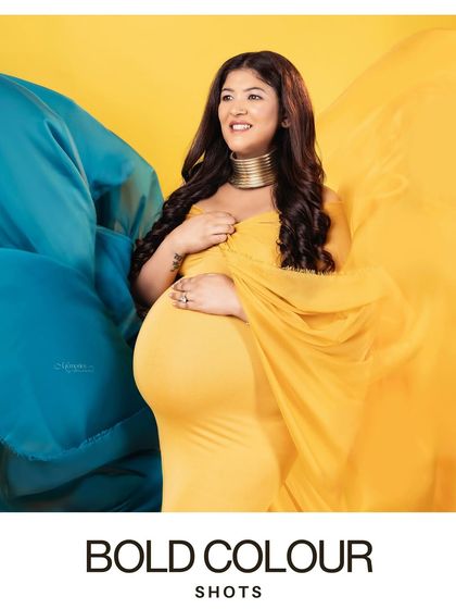 Bold color blocking makes for a powerful and modern maternity portrait. This yellow and blue combination creates a stunning visual that is both artistic and full of energy.
