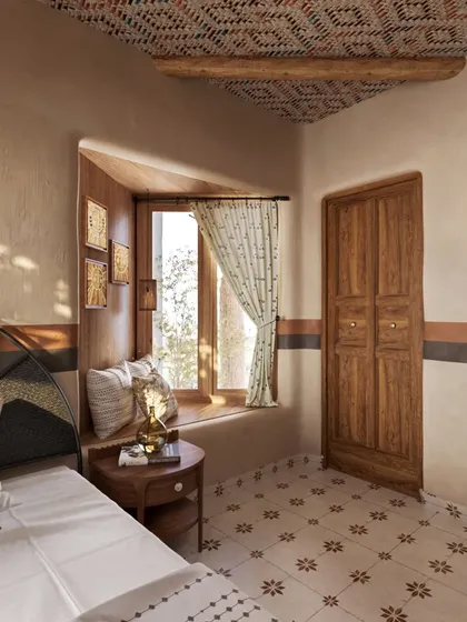 A slightly different angle of the window nook, showing the delicate pattern on the curtains. Every textile was carefully chosen to contribute to the room's overall story of simplicity and natural elegance.