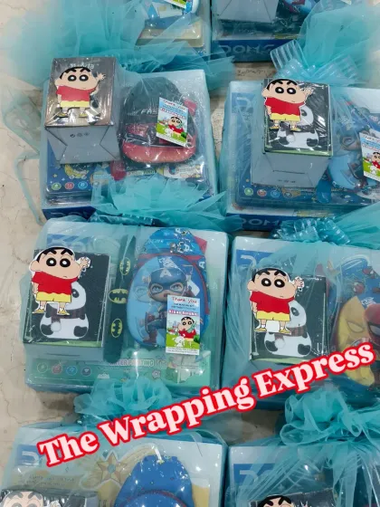 A closer look at the Shinchan themed return gift boxes, each packed with a small toy, stationery, and a thank you note.
