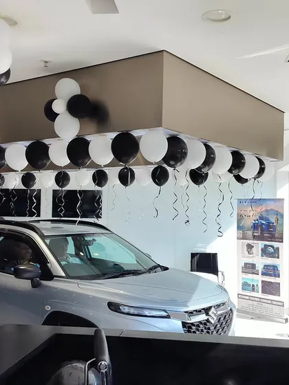 This is a look at our showroom decoration for a NEXA launch event in Nerul. We used a clean black and white balloon theme to match the brand's sophisticated aesthetic and create a festive atmosphere for new car deliveries.